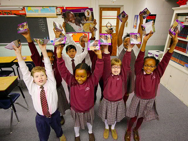 school students with cardboard rice bowls photo by Jim Stipe Catholic Relief Services 640 480px