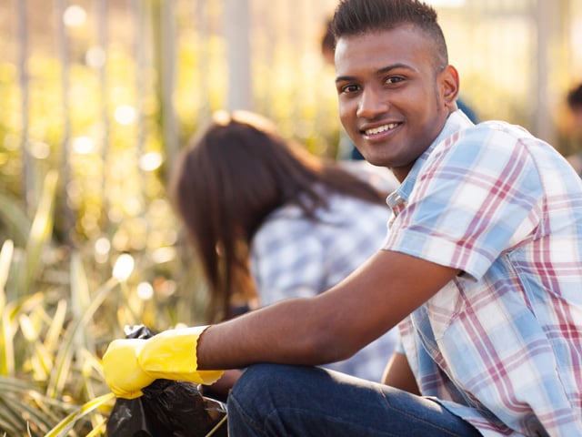teen volunteer cleaning streets with friends