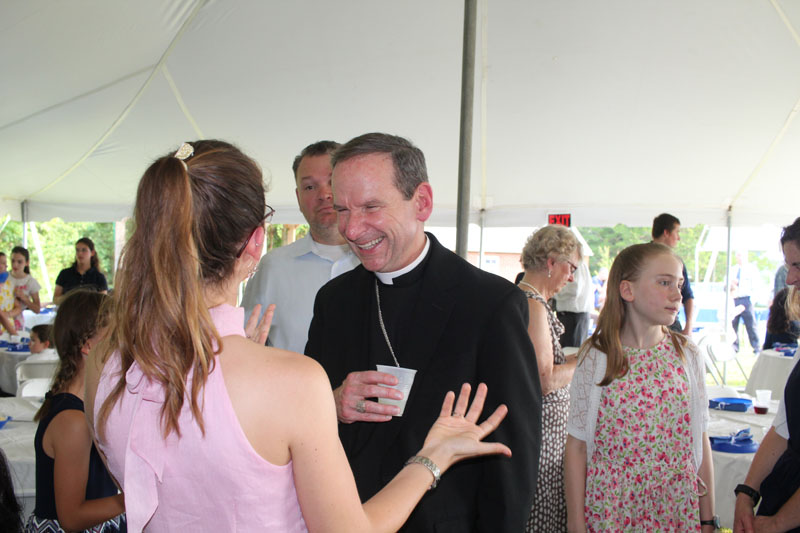 Bishop Burbidge talking with saint anthony parishioner