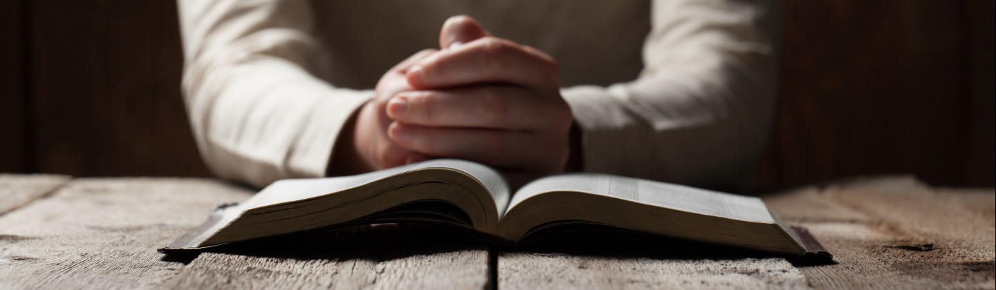 bible and praying hands 1440x420