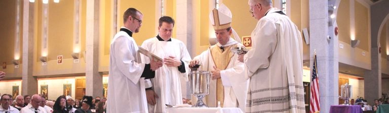 bishop burbidge pouring oil at chrism mass 2017 saint thomas more cathedral hm