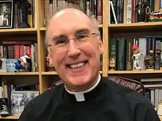 father saunders with new book 320px.jpg 1
