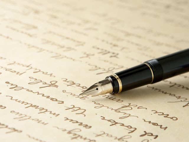 pen and paper with writing