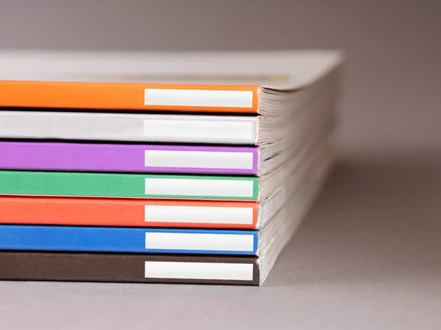 stack of notes books in various colors