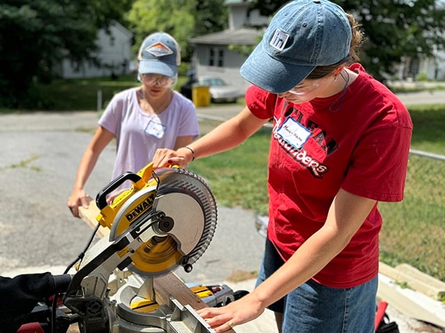teenager using mitre saw